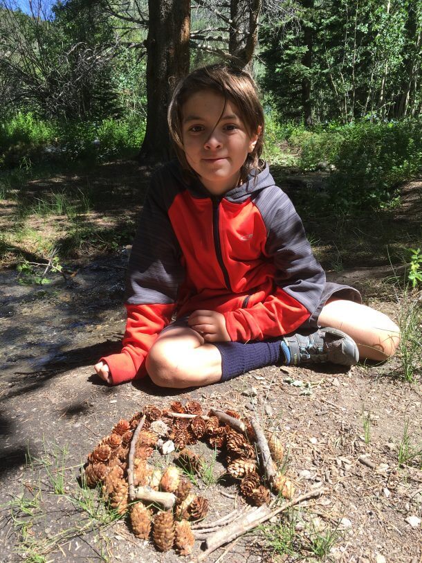 Boy playing items found in forest.