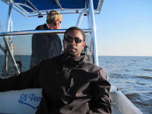 Nkrumah on a boat in sunglasses.