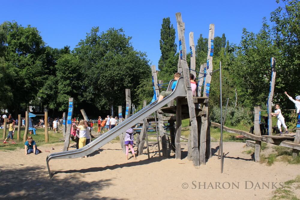 Commercial play structures can be successfully interwoven with nature-based green schoolyards through thoughtful selection of materials, design and layout. Using natural fall zone materials, like sand, softens the feel of the playground, allows rainwater to soak into the ground, and provides additional interest for children’s creative play.