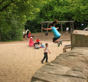 Children jumping off wooden ledges.