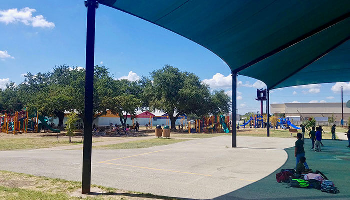 Austin, Texas schoolyard with students outside.