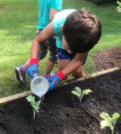 Child-sized tools allow children to take ownership of the gardens in the Children’s Courtyard. Photo courtesy of Smart Start of New Hanover County.