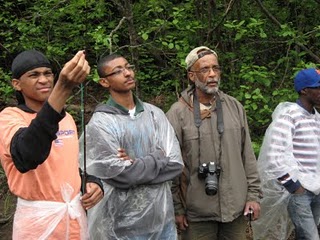 Older teen boys getting ready to fish by a river.