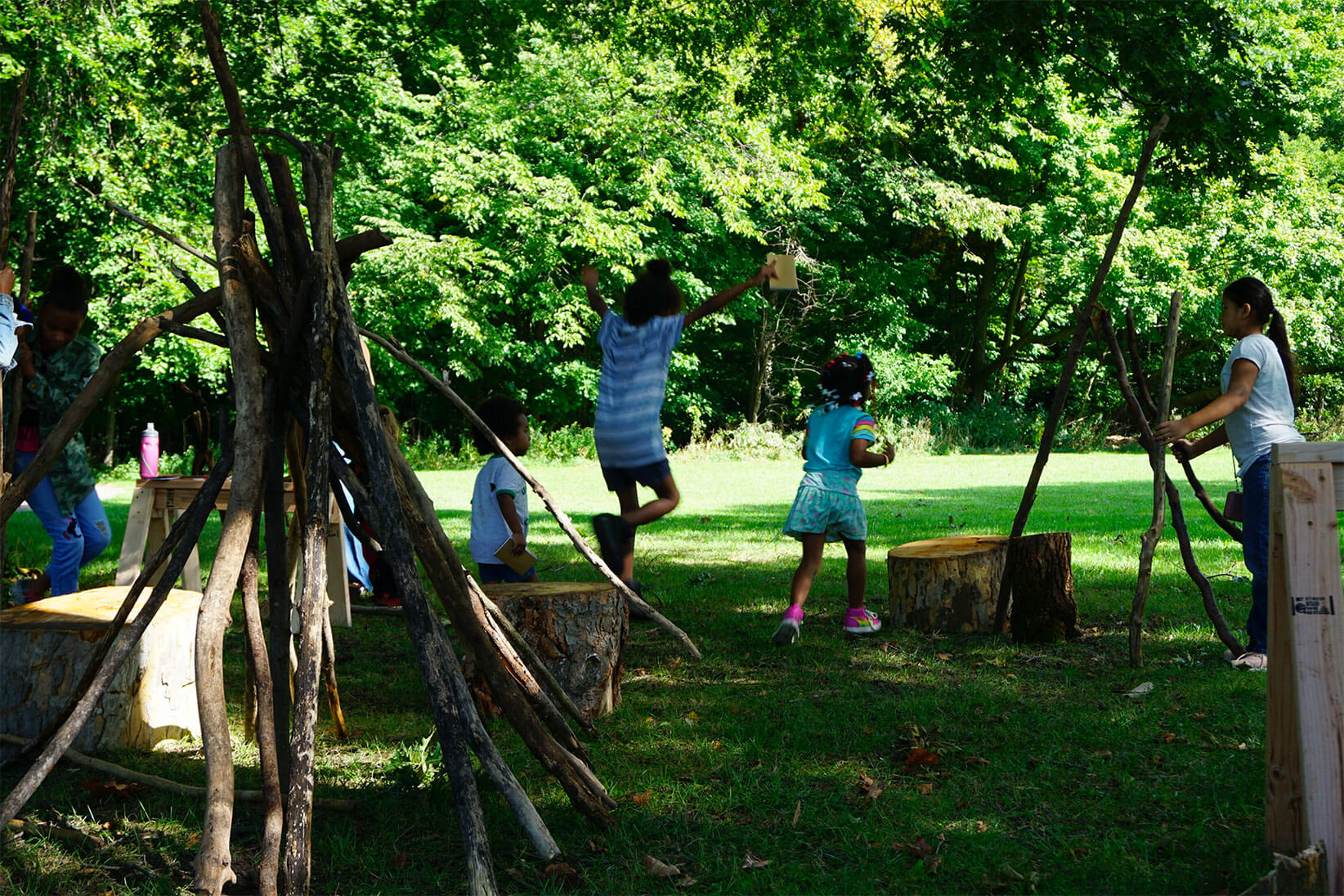 Children jumping on logs.