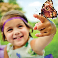 Girl holding butterfly.