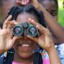 Kid using binoculars.