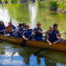 People in a Row Boat paddling together.